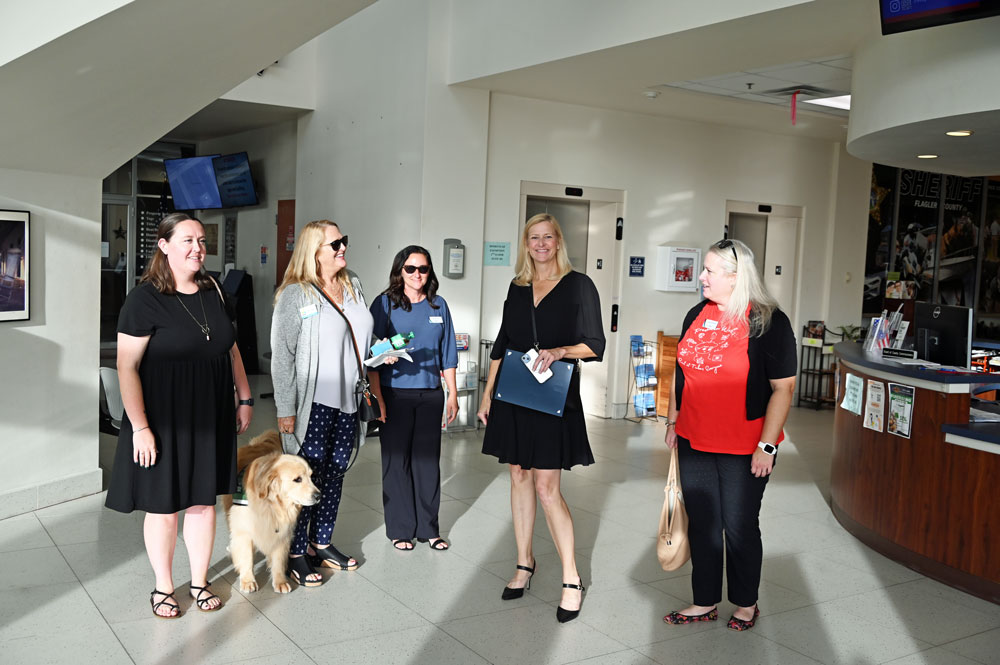 Flagler Cares CEO Carrie Baird, second from right, after a proclamation marking Flagler Cares' 10th anniversary, at a Bunnell City Commission meeting in June. All local governments adopted the proclamation. (© FlaglerLive)
