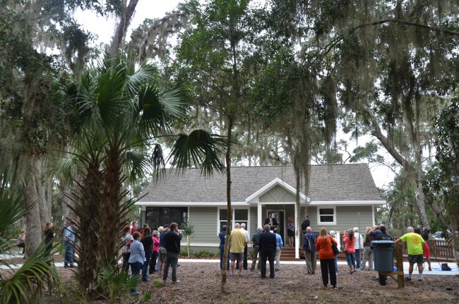 County Administrator Craig Coffey spoke at this morning's dedication of three cottages designed for use by tourists and researchers at Princess Place Preserve. Click on the image for larger view. (© FlaglerLive)