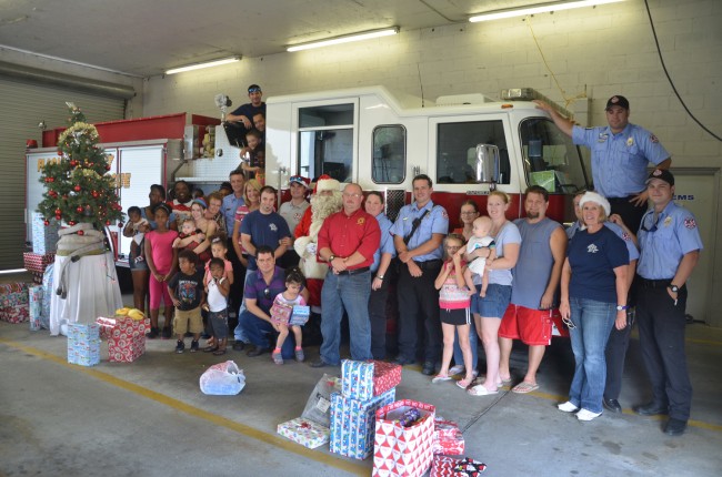 Christmas at Flagler County Fire Rescue's Station 92 today meant that 58 children got most of their wish lists filled, thanks to the donations of firefighters and their families. Click on the image for larger view. (© FlaglerLive)