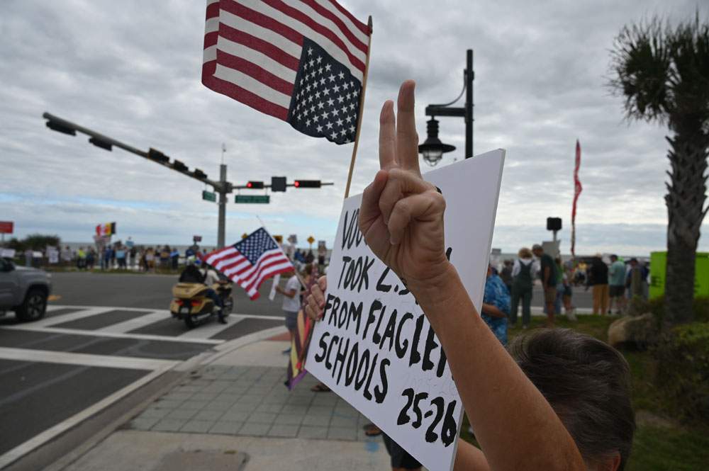 Karen Martin was protesting the trickle-down effect of Trump's cuts in education. (© FlaglerLive)