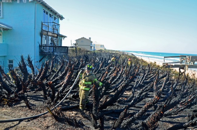 The charred backyard at 3431 North Ocean Shore. The fire consumed about one acre. The house was under renovation. Click on the image for larger view. (© FlaglerLive)