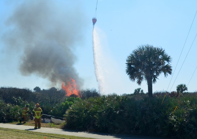 Flagler County Fire Flight dumped dozens of water loads on the fire after it jumped A1A and began moving toward Island Estates, flaring up on several occasions. Click on the image for larger view. (© FlaglerLive)