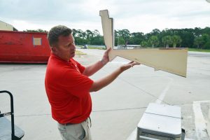 Operations Director Thomas Laraway displays a cross-section of the structural foam that fills Boston Whaler hulls, making them unsinkable. (© FlaglerLive)