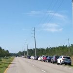 The number of families needing help from Grace Community Food Pantry off U.S. 1 every weekend has nearly doubled since the coronavirus emergency began, as was the case with vehicles lining up along the highway last Saturday. (© FlaglerLive)
