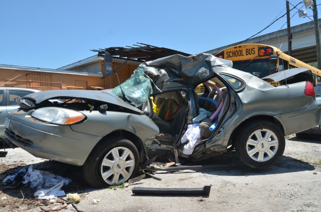 The Ford Taurus after it was towed from the scene. The tree it struck left a deep impact on the driver's side door. Click on the image for larger view. (c FlaglerLive)