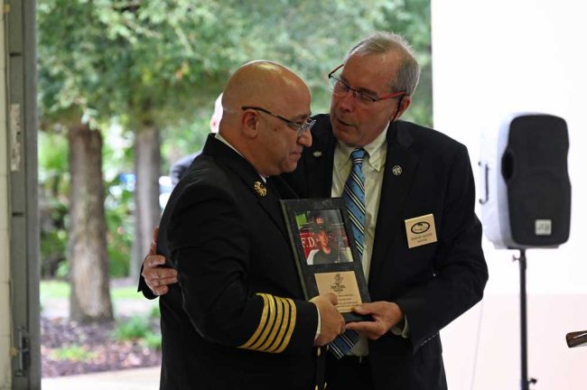 Palm Coast Mayor David Alfin presenting the award to Fire Chief Jerry Forte. (© FlaglerLive)