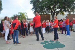 Brun Hudson, president of the the Flagler Educational Support Personnel Association, addressing the gathering at FPC, with teacher Debbie Couch to the right. (© FlaglerLive)