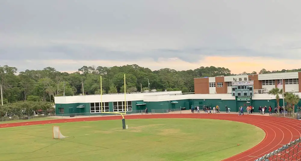 A 19-year-old man who'd been involved in an altercation off campus jumped a fence onto Flagler Palm Coast's athletic fields this afternoon before he was apprehended. (© FlaglerLive)