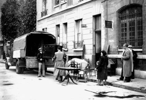 Furniture confiscated from Jewish homes is delivered to other people in Boulogne-Billancourt, Paris in April 1942, after an Allied bombing. Art Media/Print Collector/Getty Images