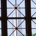 The Freedom Tower in Manhattan, seen through a window of the Great Hall on Ellis Island. (© Pierre Tristam)