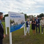 As AdventHealth Palm Coast Foundation Executive Director John Subers looked on, AdventHealth Palm Coast CEO Denyse Bales-Chubb this morning unveiled plans for a 30,000 square foot medical building on the front parcel of the hospital on State Road 100, named for Peter and Sue Freytag, (third and fourth from left), who marked the unveiling with Foundation Chairman Papanderou. (© FlaglerLive)