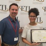 Program Facilitator Travis Thomas (left) with Jalyn Clavizzao (right) receiving her certificate