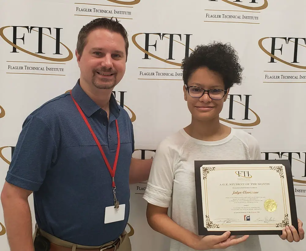 Program Facilitator Travis Thomas (left) with Jalyn Clavizzao (right) receiving her certificate