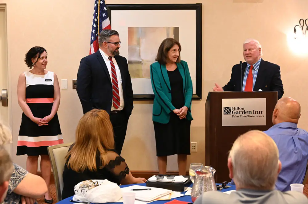 The Flagler County Republican Club's Ed Fuller introducing Flagler County Judge Andrea Totten, Circuit Judges Kenny Janesk, who sits in Volusia and Putnam, and Stacia Warren, who sits in Volusia. (© FlaglerLive)