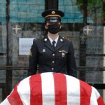 Sgt. Nikole Clark, a member of the New York National Guard Military Funeral Honors Team, stands posted at the casket of U.S. Army Air Force Cpl. Raymond Kegler during his funeral in Lackawanna, New York, May 14. Clark wore a face mask as part of precautions being used during military funerals to prevent the spread of COVID-19. (Army National Guard Photo by Capt. Avery Schneider)