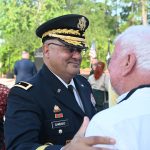 Charles Gambaro, a brigadier general in the Army Reserve, speaking with Ed Fuller at last May's Memorial Day ceremony in Palm Coast, an event U.S. Rep. Randy Fine attended. (© FlaglerLive)