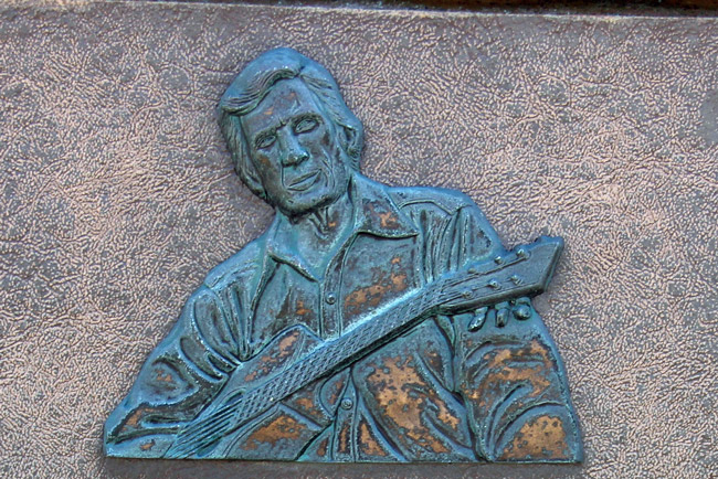 Gamble Rogers, in a detail from the plaque in his honor at Gamble Rogers State Recreation Area at Flagler Beach. The plaque would be the only remnant to his memory if the area's name is changed in accordance with the city's wishes. (© FlaglerLive)