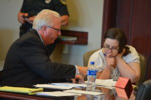 Defense attorney Garry Wood and Erin Vickers go over the list of potential jurors before the final culling. (© FlaglerLive)