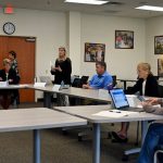 School Board Attorney Kristy Gavin, standing, explaining the legalities of recordings at public meetings, an issue that caused Flagler County School Board members to stop their training workshop today for 27 minutes. Two of the board members wanted to bar recordings at the session, which would have violated open-meeting laws. (© FlaglerLive)