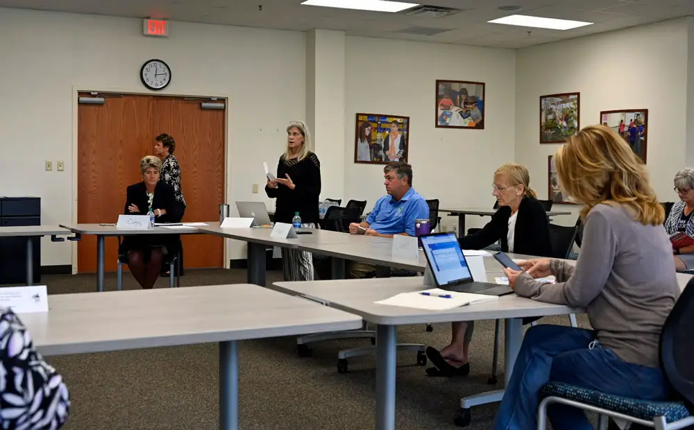 School Board Attorney Kristy Gavin, standing, explaining the legalities of  recordings at public meetings, an issue that caused Flagler County School Board members to stop their training workshop today for 27 minutes. Two of the board members wanted to bar recordings at the session, which would have violated open-meeting laws. (© FlaglerLive)