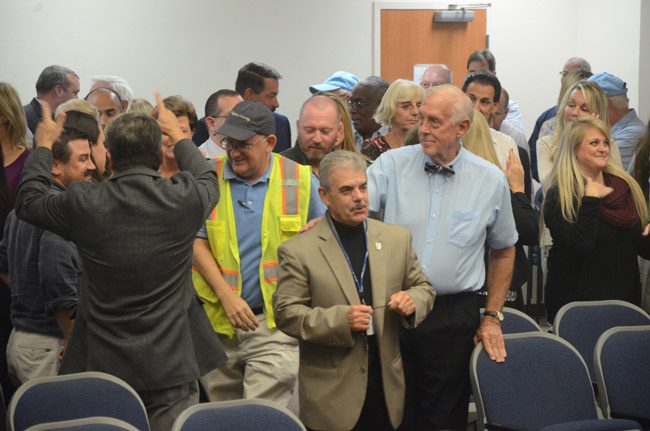 Commissioner George Hanns, center, with fellow-Commissioner Charlie Ericksen, who'd just finished roasting him at a farewell reception for Hanns. (© FlaglerLive)