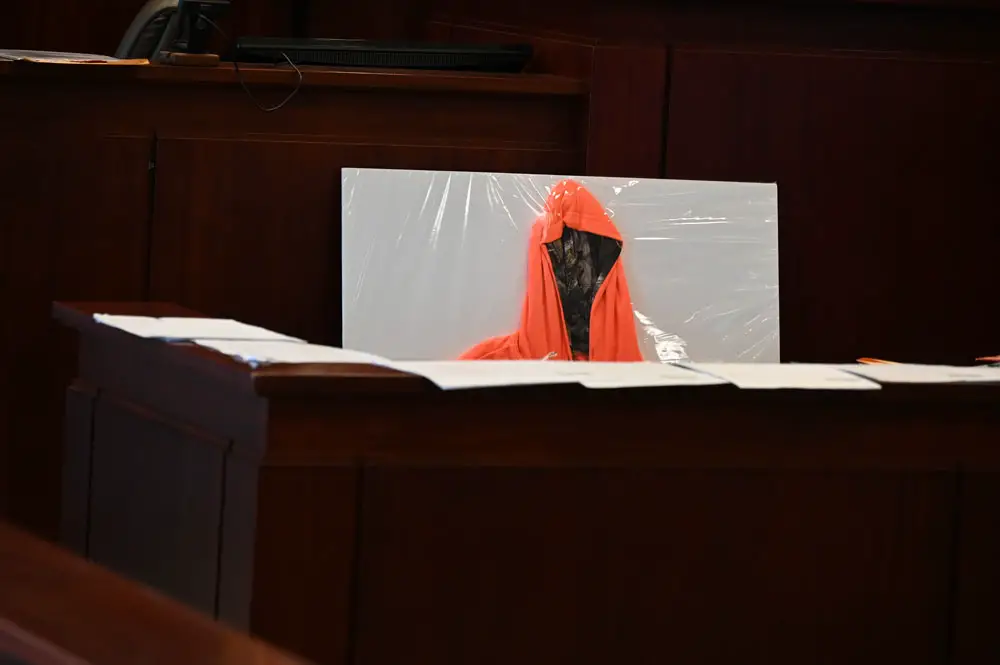Ghostly evidence: the hoodie Deon Jenkins was wearing the morning he was shot and killed, as placed, for the duration of the trial, just behind the clerk, in full and constant view of the jury. Today, during closing arguments, prosecutors placed the hoodie in front of Marcus Chamblin. (© FlaglerLive)
