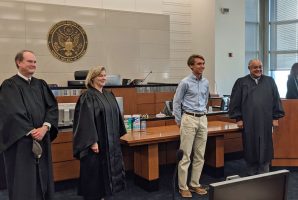 Flagler Palm Coast High School junior Sean Gilliam with, from left, District Judges Timothy Corrigan, Marcia Morales Howard and and Brian Davis. Corrigan and Morales were appointed by President George W. Bush, Davis by President Obama. (Allison Elledge)