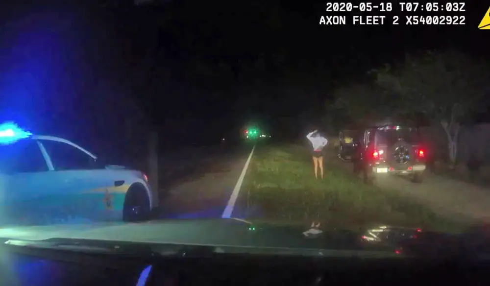 The girl complying with deputies' commands as she stepped away from the Jeep she had sped through various areas of Palm Coast's P Section early this morning. (FCSO)