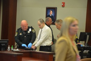 Verdone being fingerprinted after the verdict as Assistant State Attorney Christy Opsahl walks out to get congratulated by her colleagues. Click on the image for larger view. (© FlaglerLive)