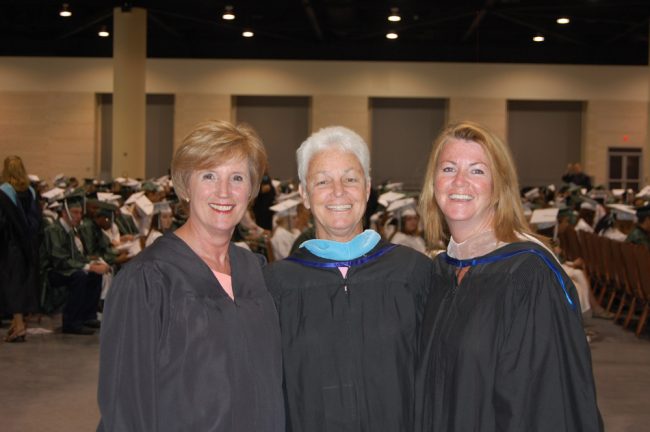 The good days. From left, School Board member Sue Dickinson, Evie Shellenberger and Colleen Conklin in 2010, at the two high schools' graduation ceremonies. (© FlaglerLive)