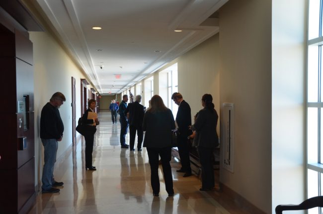 Members of Bobby Gore's family and friends speaking with Gore's attorney, Ray Warren, before the three-hour hearing this afternoon at the Flagler County Courthouse. (© FlaglerLive)