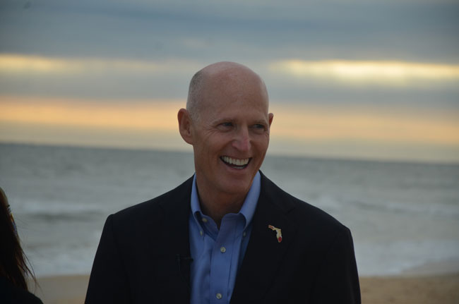 Gov. Rick Scott, who stopped in Flagler last week to announce some emergency spending on beach repairs, has been touring the state to preview parts of his budget. (c FlaglerLive)