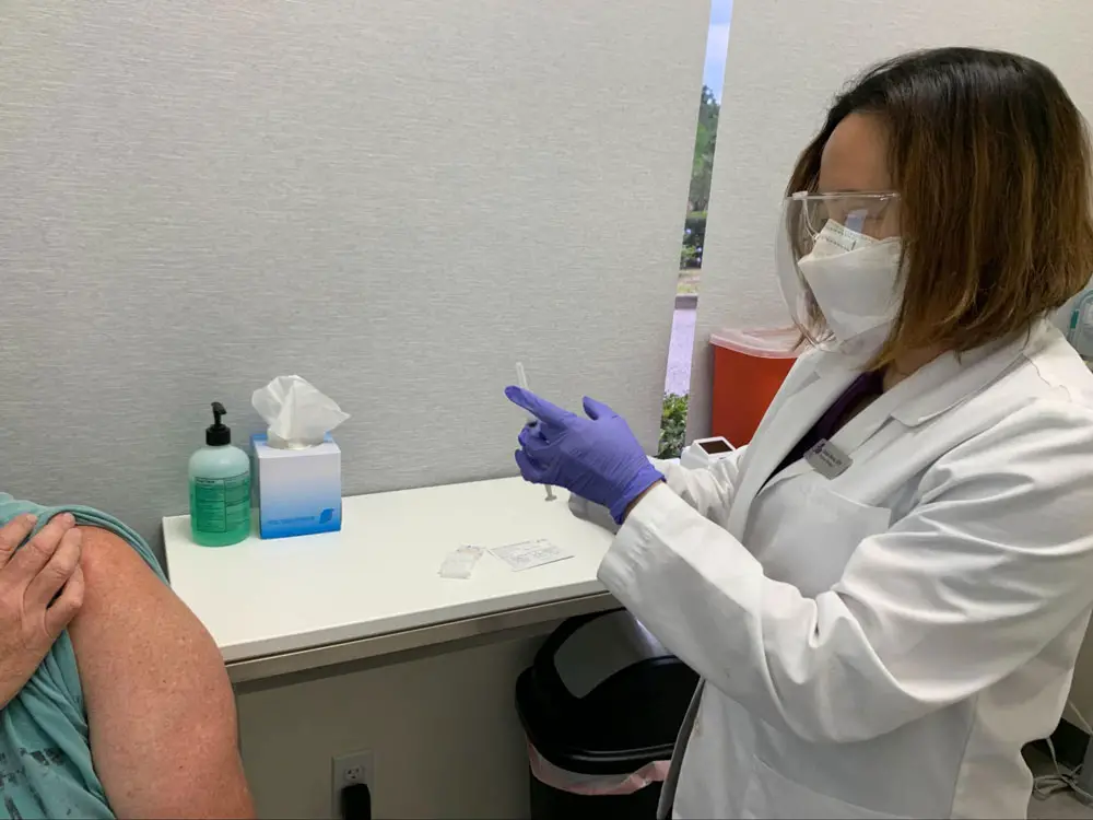 Grace Benet administers all vaccines at Grace Community Pharmacy, which launched a partnership with the Flagler Health Department in March. (© FlaglerLive)