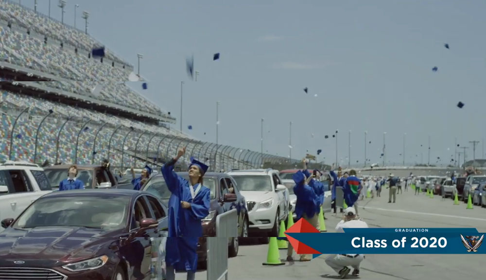 Caps went airborne as Matanzas High School graduates prepared for their victory lap this morning at the Daytona International Speedway. (© FlaglerLive via Flagler Schools)