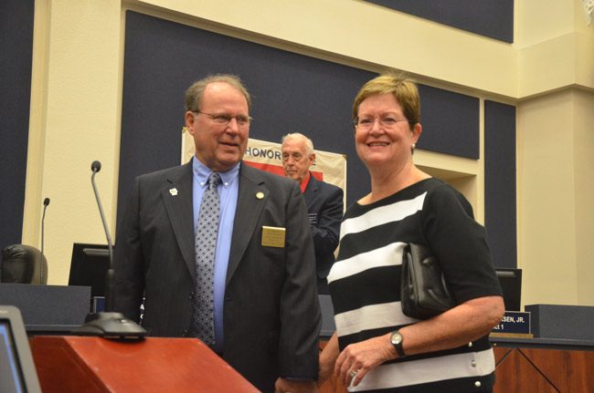 Greg Hansen and his wife Linda Hansen immediately after the swearing in by County Judge Melissa Moore-Stens. Commissioner Charlie Ericksen is in the background. (© FlaglerLive)
