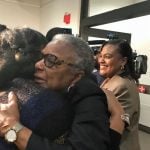 Carol Greenlee, daughter of Charles Greenlee, of the Groveland Four, gets hugs after her deceased father is pardoned by the state’s clemency board (Photo by Diane Rado/Florida Phoenix)
