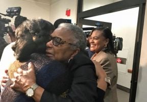 Carol Greenlee, daughter of Charles Greenlee, of the Groveland Four, gets hugs after her deceased father is pardoned by the state’s clemency board (Photo by Diane Rado/Florida Phoenix)