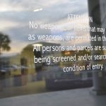 The sign stenciled on the entrance door at the Government Services Building in Bunnell, where county and school district offices are located, and where students are routinely in the building. (© FlaglerLive)