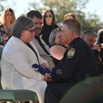 Andrea Feagle, Sgt. Dominic Guida's older sister--one of three siblings--after receiving the ceremonial flag from Police Chief Tom Foster. (© FlaglerLive)