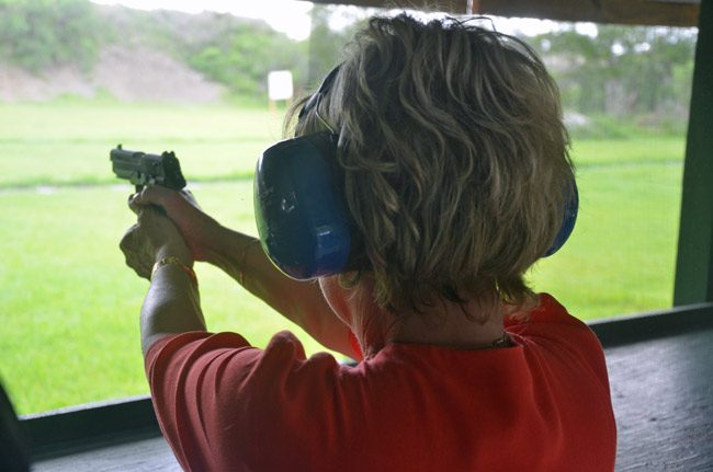 Flagler County Tax Collector Suzanne Johnston practicing shooting at the county's gun range last June, as part of her getting a concealed-carry permit. (© FlaglerLive)