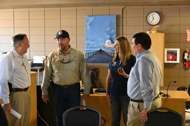 Kevin Guthrie, second from left, the state director of emergency management, was back among familiar faces, with City Manager William Whitson, County Administrator Heidi Petito and Flagler Emergency Manager Jonathan Lord in a debriefing after the governor left. (© FlaglerLive)
