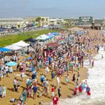 A drone view of just one half the segment of beach taken up by the Hang 8 Dog Surfing competition at its height this morning in Fl;agler Beach, showing the huge crowd. (© Scott Spradley for FlaglerLive)