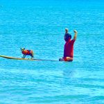 * Palm Coast resident JJ Crane raises his arms in triumph after he and his dog Ocean, a Chi-weenie, completed a run that helped them win the Human/Dog Tandem Surfing category at the 4th Hang 8 Dog Surfing Extravaganza. Ocean also won the Small Dog Surfing category and Best Wave in both the Small and Human/Dog Tandem categories. FlaglerLive photo