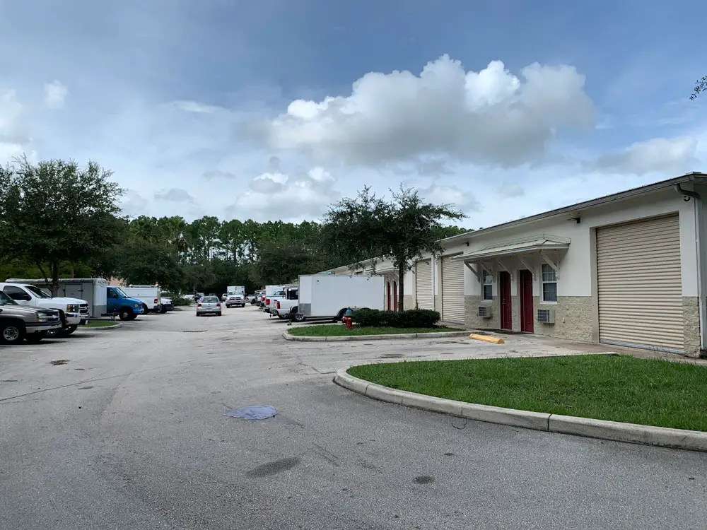 The shooting Saturday took place at 5F, in the garage to the right, in the sprawl of hangar-like businesses at Hargrove Lane in Palm Coast. (© FlaglerLive)