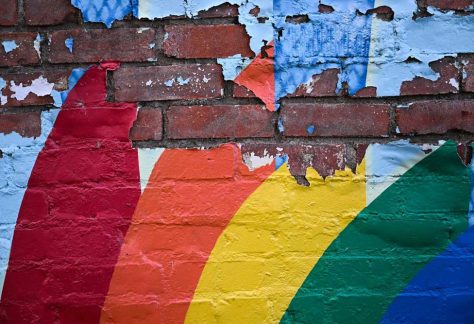 A painted rainbow peels off a wall in Laramie, Wyo., where nearly 26 years ago Matthew Shepard was killed.