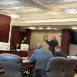Daniel Webster, representing the Flagler Home Builders Association, arguing the HBA case at the lectern before Circuit Judge Sandra Upchurch this morning. The HBA's Annamaria Long is to the right. Jared Gainey, representing the city, is seated to the left of Webster. (© FlaglerLive)