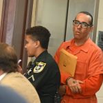 Kristopher Henriqson arriving in court last week. Assistant Public Defender Spencer O'Neal is in the foreground. (© FlaglerLive)