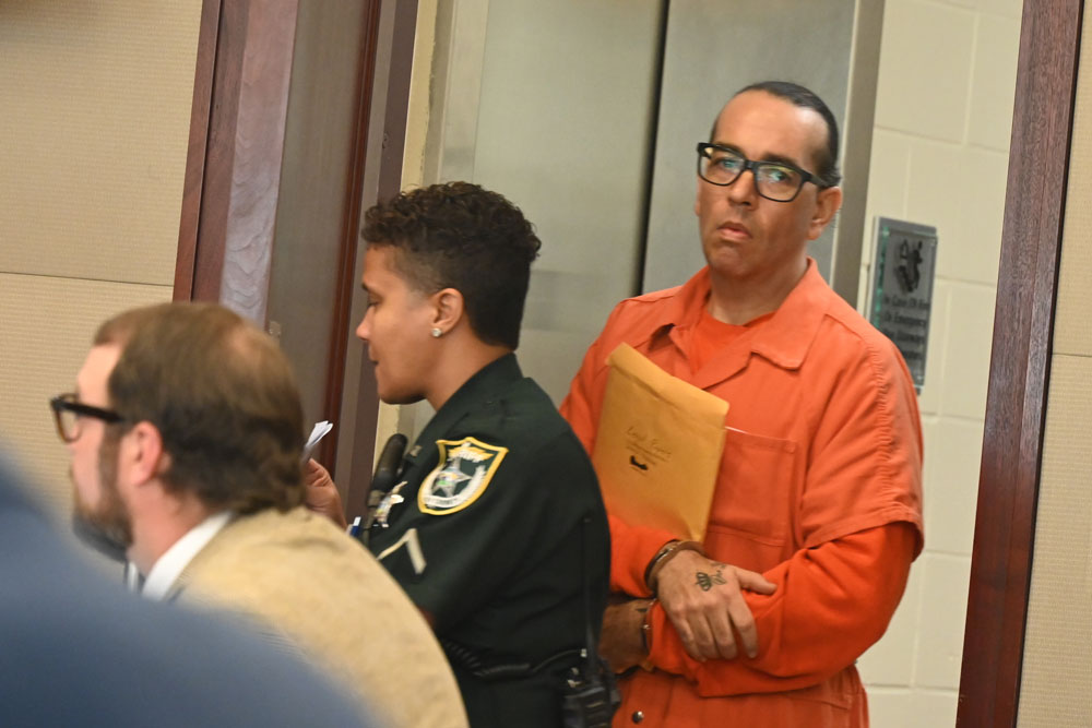 Kristopher Henriqson arriving in court last week. Assistant Public Defender Spencer O'Neal is in the foreground. (© FlaglerLive)