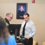 Kristopher Henriqson getting fingerprinted after his trial and convictions last month. (© FlaglerLive)