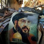 A picture of the secretary-general of Hezbollah Hassan Nasrallah is seen among the rubble following an Israeli air strike.